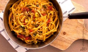A photo of a yummy linguini pan with fennel, capers, sun-dried tomatoes and ouzo sauce. A vegan recipe from All About Vegans.