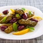 Stuffed grape leaves with vegan white béchamel sauce