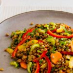 Photo of lentil salad. With brown lentils and sweet sour curry sauce. A vegan recipe.