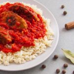 Lentils' soutzoukakia (kebab) with tomatoe sauce and rice. Lentils kebab (souzoukakia). A plant-based, vegetarian and vegan recipe.