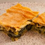 Photo of two pieces of Greek spinach, leeks and fennel pie. A vegetarian and vegan recipe.