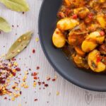 Photo of a plate with lima beans in tomato sauce. A vegan recipe from All About Vegans.