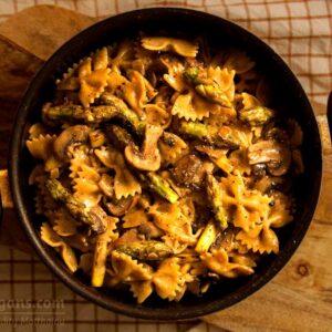 Photo of whole wheat farfalle with asparagus and mushrooms in white almond milk sauce. A vegan recipe from All About Vegans.