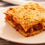 Photo of Greek vegan moussaka. Vegan moussaka with grilled potatoes and eggplants and almond milk and olive oil béchamel. A vegan and vegetarian recipe from All About vegans.