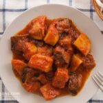 Photo of a yummy stew with eggplant and potatoes in tomato sauce. Α vegan and vegetarian recipe from All About Vegans.