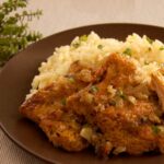 Photo of a dish with soya fillets in olive oil oregano sauce and rice pilaf. A vegan and vegetarian recipe from All About Vegans.