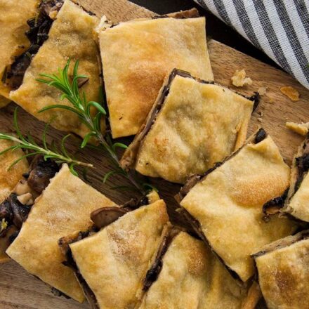 Photo of pieces of vegan mushroom pie with rosemary and crunchy handmade homemade phyllo dough. A vegan, vegetarian and fasting recipe from All About Vegans.