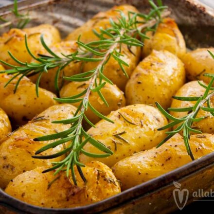 Photo of a pan with roasted baby potatoes with rosemary. A vegan and vegetarian recipe from All About Vegans.