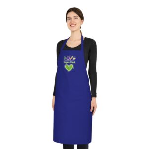 photo of a smiling girl wearing a blue cotton apron with printed vegetables and the words vegan cook